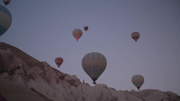 Hot air balloons take off from the fields around Goreme, Cappadocia, at sunrise