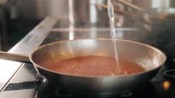 Chef Cooking Tasty Pasta Tomato Sause on Restaurant Kitchen Traditional Italian Food High Kitchen