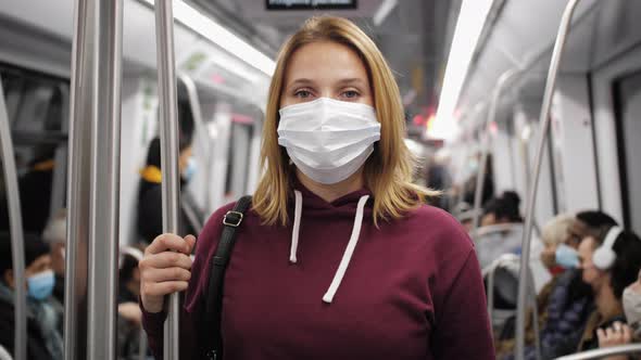 Portrait of Passenger with Wearing Protective Medical Mask During Ride in Metro Train