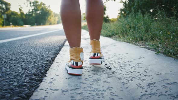 Female Legs Walking Along Road Tourism Concept