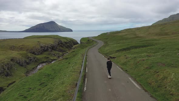 Young Skater Riding a Skateboard Through the Beatiful Scenery of Faroe Islands