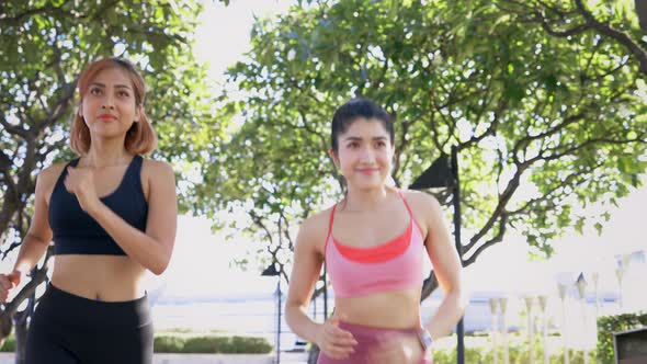 Female Friends Running in Park