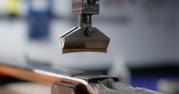 Process of Press Fitting the Frets Into the Guitar Fretboard at the Luthier's Workshop Guitar Repair