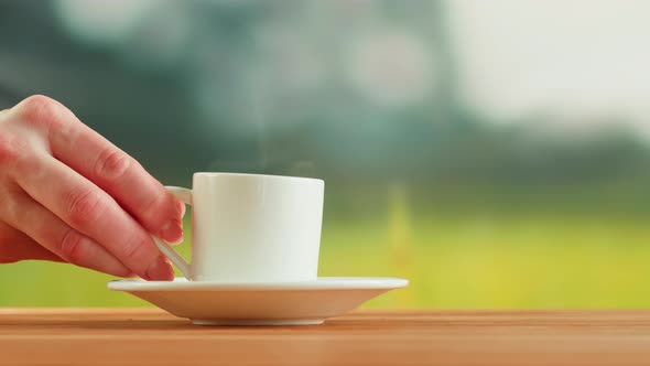 Hot Coffee in White Cup on a Wooden Table