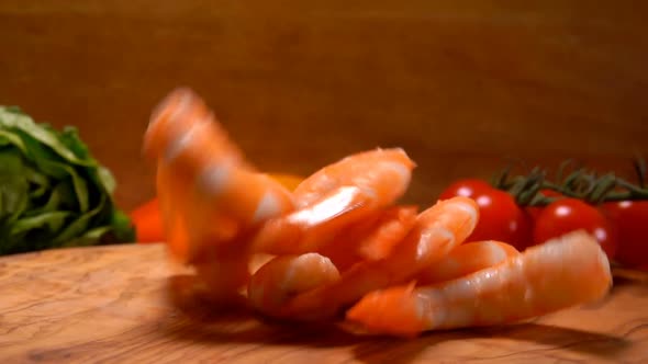 Delicious Peeled Shrimps Fall on a Wooden Board