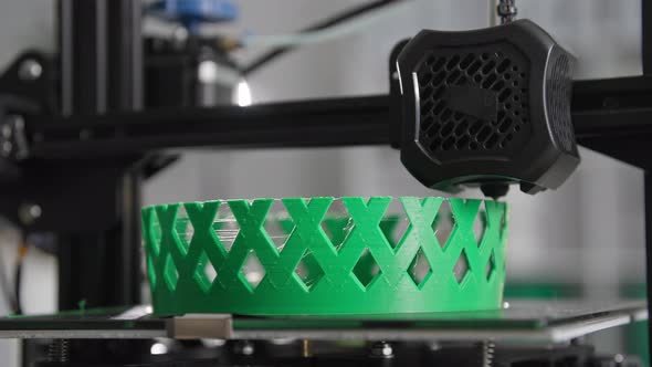 Modern Technologies at Home Automatic 3D Printing Prints Layer By Layer of Hot Green Plastic