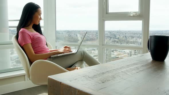 Woman using laptop in living room