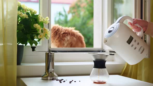 Unrecognisable Person Pouring a Hot Water Into Filter Coffee Maker