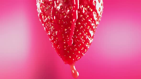 Slow Motion Macro Shot of Flowing Juice From Strawberry