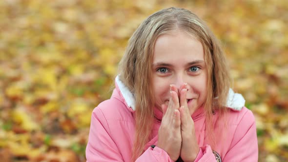 Teenage Girl Freezes in the Autumn Park