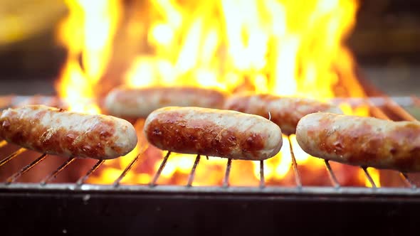 Delicious juicy Sausages, Cooked on the Grill with a Fire