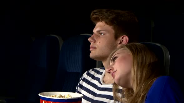 Couple Feeding Each Other at the Cinema. Close Up
