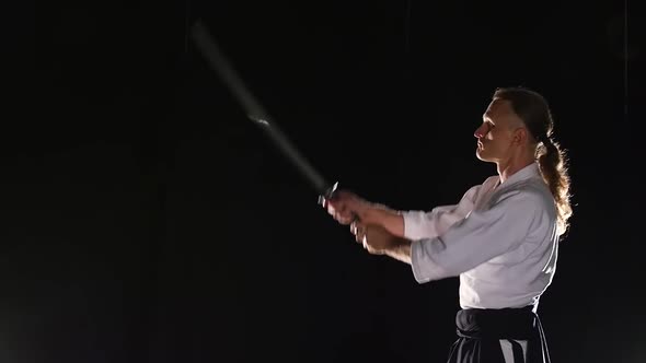 Man Fighting at Aikido Training with Japanese Sword Katana in Martial Arts School. Healthy Lifestyle