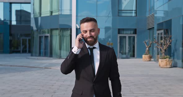 Confident Businessman Going To Office and Talking on Mobile Phone