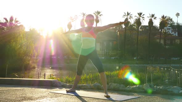 Woman Doing Yoga In The Park At Dawn