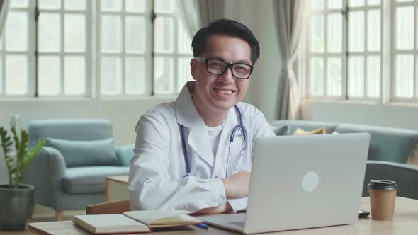 Asian Male Doctor Smiling At Home Office