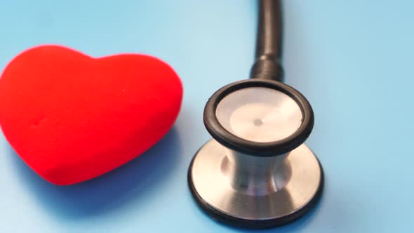 Heart Shape Symbol and Stethoscope on Blue Background