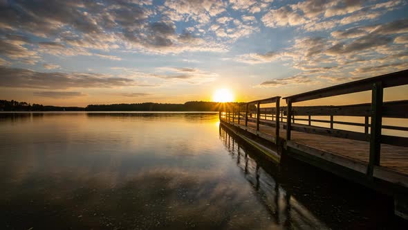 Sunset Over Lake Time Lapse. Clouds Reflecting in Calm Water. Lake Wdzydze, Kashubia,Poland.