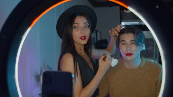 Makeup Studio - Young Handsome Man with Bold Red Lipstick and His Make Up Artist Standing in Front