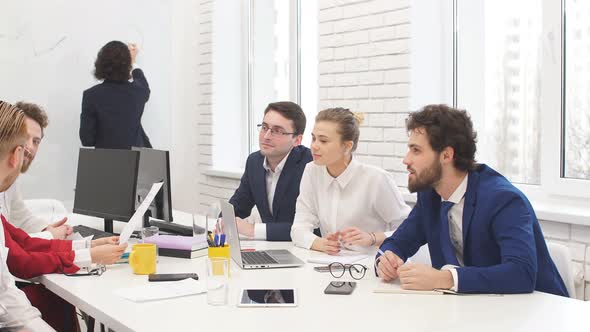 Friendly Business Team Together in Light Boardroom