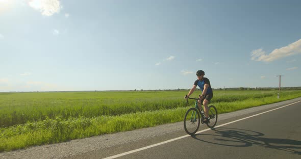 A Cyclist is Riding on the Road