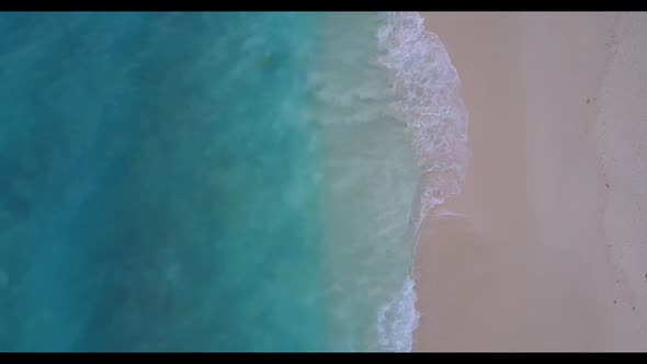 Aerial flying over panorama of paradise island beach holiday by blue ocean and white sandy backgroun