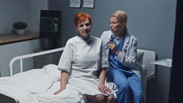 Doctor Using Stethoscope on Woman