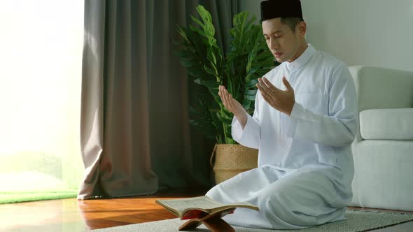 Asian Muslim Man Praying at Home