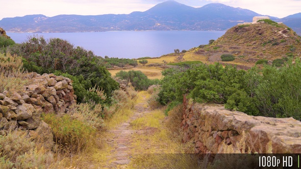 Traveling down an ancient Greek cobblestone path in the countryside of Milos, Greece