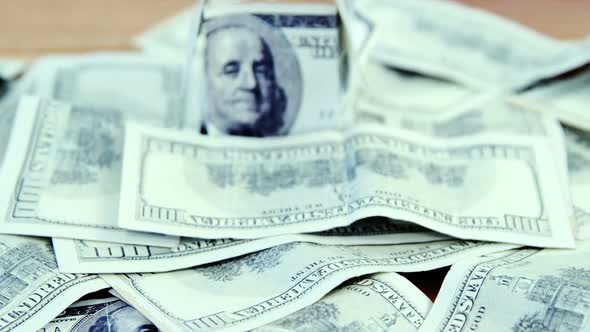 Lots of dollar bank notes scattered on the table