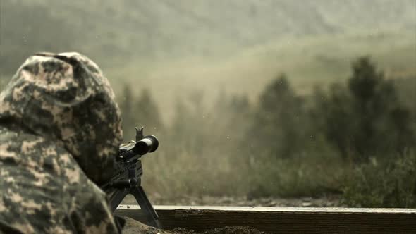 Super slow motion shot of soldier shooting chain gun; training at firing range.