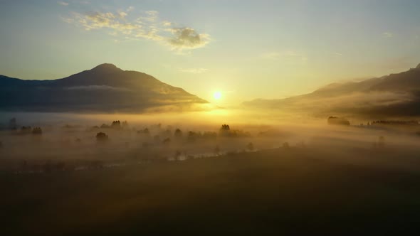 Drone Over Ethereal Misty Landscape Of Zell Am See Towards Sunrise