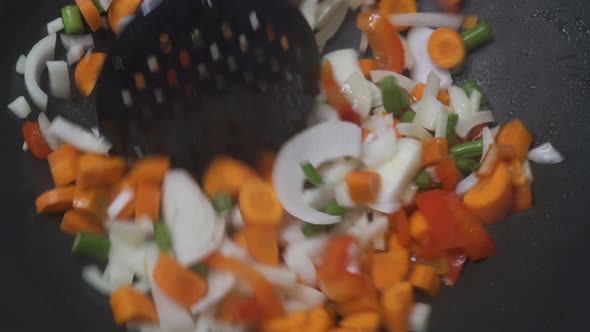 Adding fresh vegetables to wok, steamy stir Fry  colorful