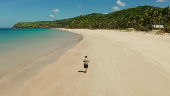 Man Jogging on the Beach in Summer