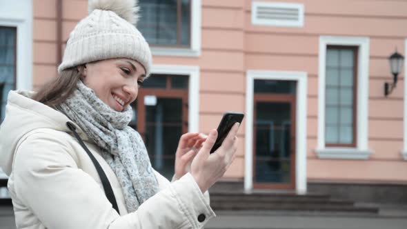 Happy Caucasian Woman Laughing and Chatting with Friends