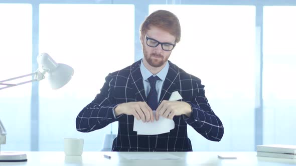 Angry Redhead Man Tearing Papers in Office, Fail Work