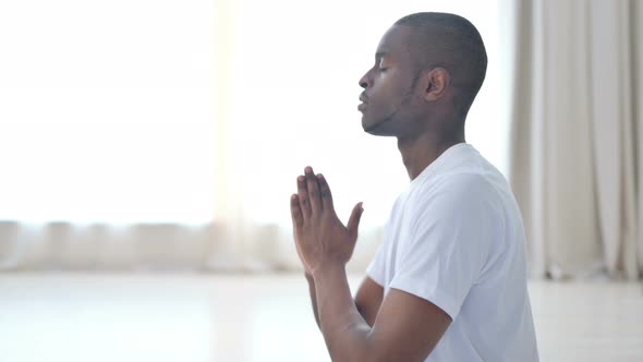 Close Up of African Man Doing Meditation with Eyes Closed