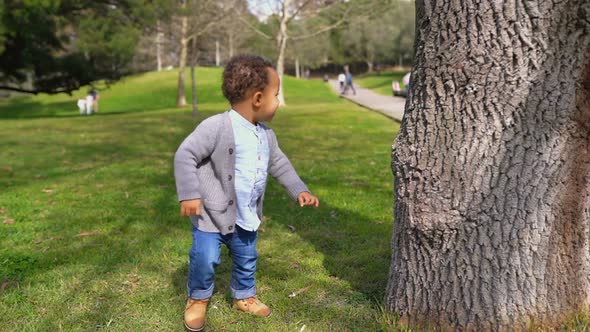 Little Boy Running Around Tree, Playing Hide-and-seek, Smiling