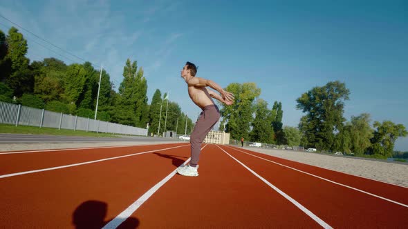 Athletic Man Doing Extreme Backflip Outdoors at Stadium Flipping with Camera