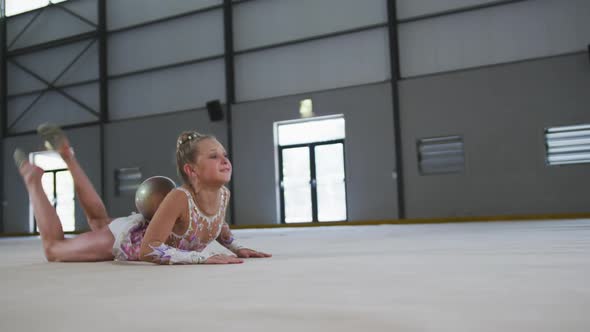 Teenage female gymnast performing at sports hall