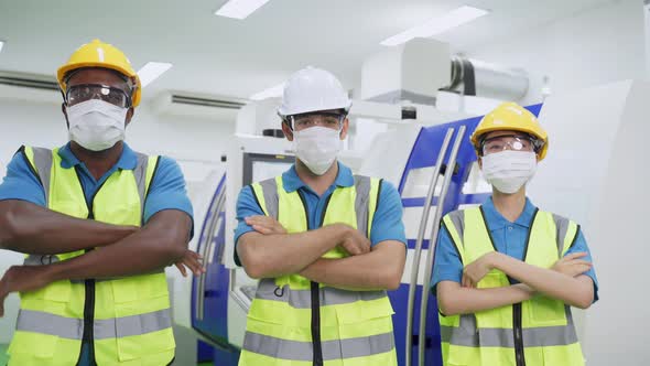 Group of male and female diversity worker people wearing protective face mask in production factory.