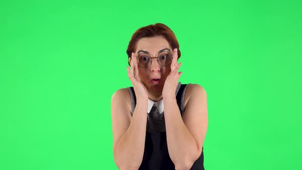 Portrait of Funny Girl in Round Glasses with Fear and Horror Looking Forward, Green Screen