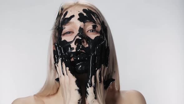 Attractive Girl Apply Cosmetic Mask Close Up. Environmental Pollution. Black Oil