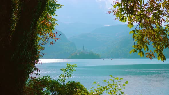 View of Blue Bled Lake and High Mountains Opens From Bank