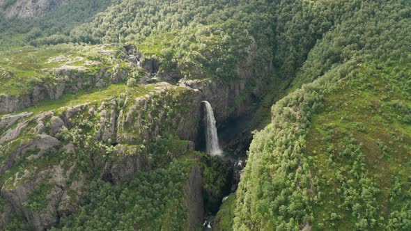 Drone Over Waterfall In Lush Valley