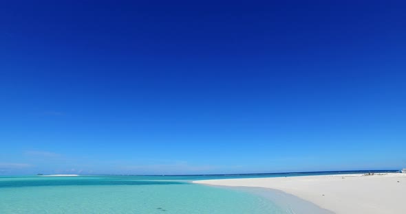 Wide angle drone abstract view of a sandy white paradise beach and aqua blue water background in hig