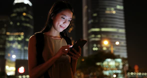 Asian woman use of cellphone in the city