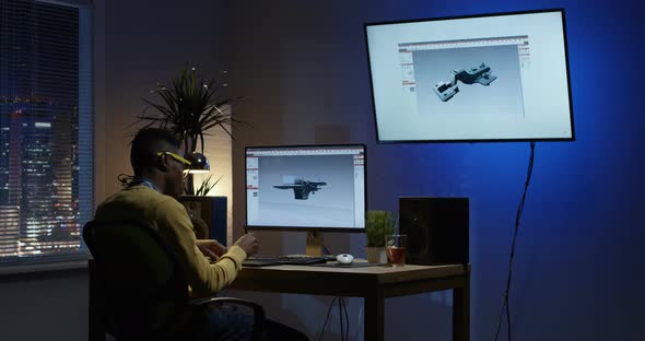 Young Man Sitting Back and Editing an 3D Model on His Computer
