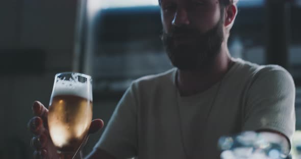 Man drinking a crafted lager beer afterwork in a urban modern bar