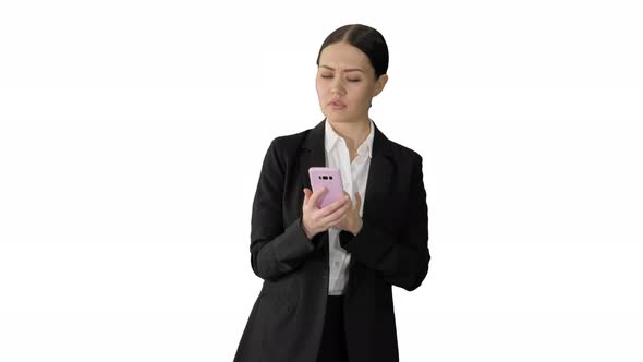 Disapprovingly Looking Business Woman Using Her Phone on White Background